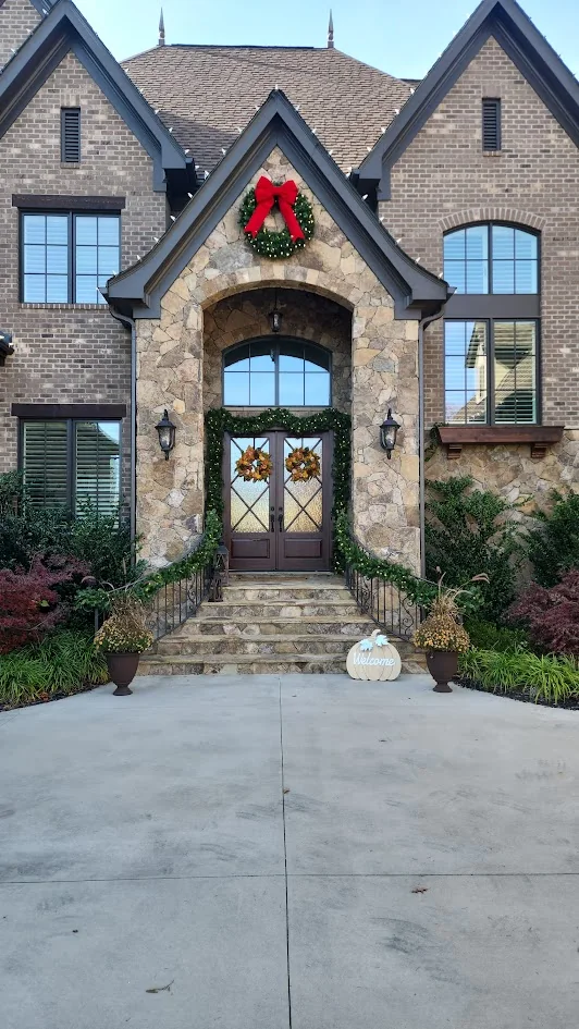 Wreath and garland installed around the entry of a Charlotte-area home